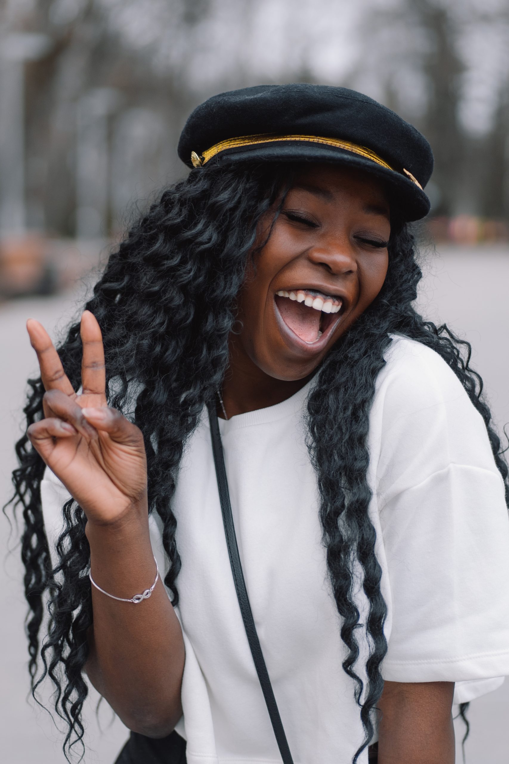 photo portrait of cheerful black skinned girl. afro girl walking in city park.